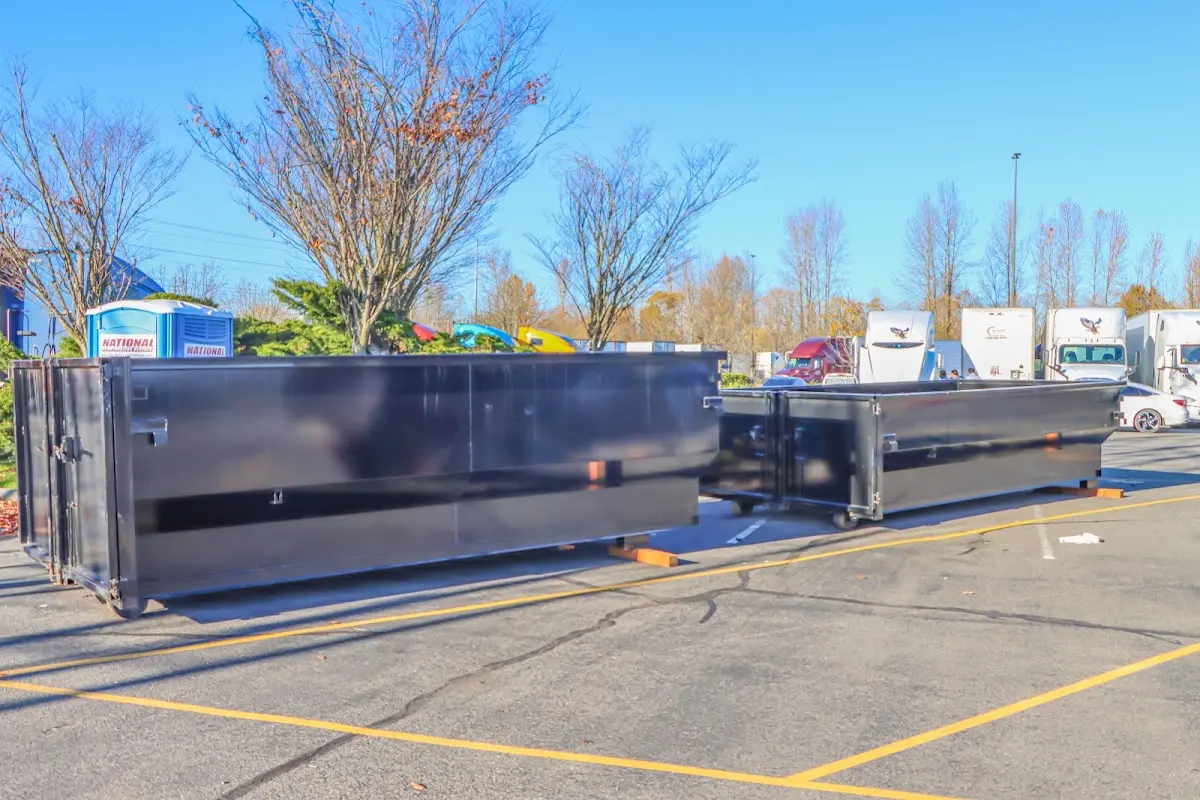 Professional dumpster rental service with roll-off container on residential driveway in Sealy